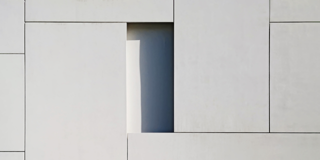 cropped close up of building with boxed design and window