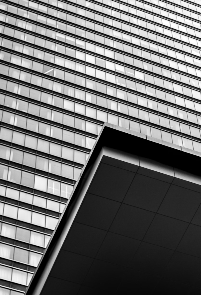 cropped view of building with tight spaced windows and drive overhang